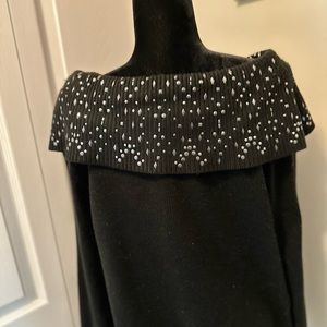 Black cowl neck sweater with silver accent.